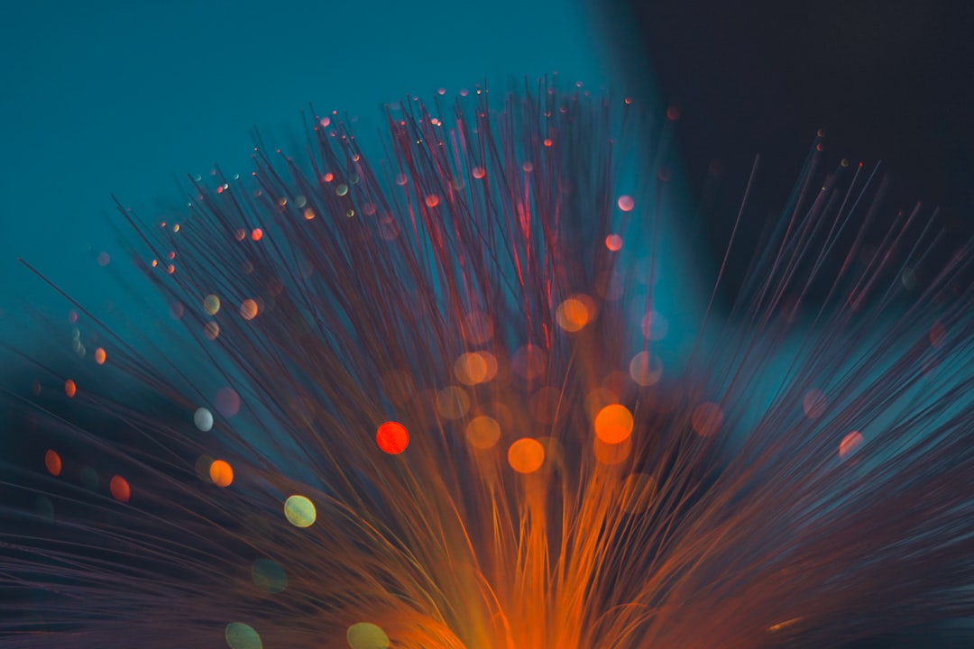 Fibre optic cable strands lit up in orange and blue